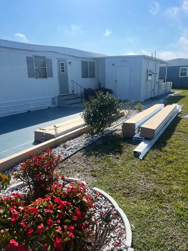 Carport materials staged at mobile home | construction work in progress in Venice, FL by Sosnin Builders