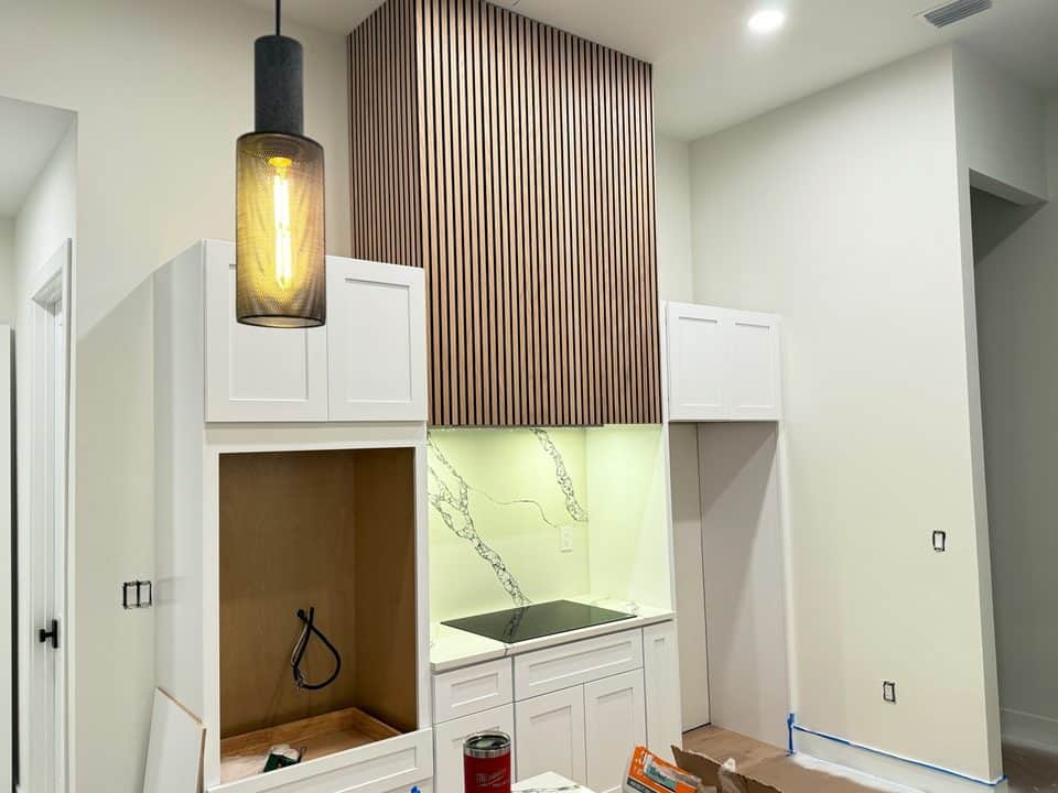 Slat-wood range hood and pendant light detail | custom home building in Port Charlotte, FL by Sosnin Builders