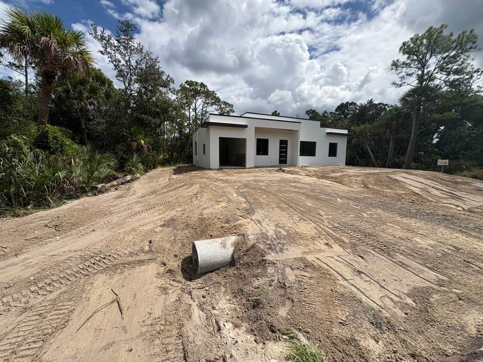 Modern flat-roof home after stucco and paint | new home construction in North Port, FL by Sosnin Builders