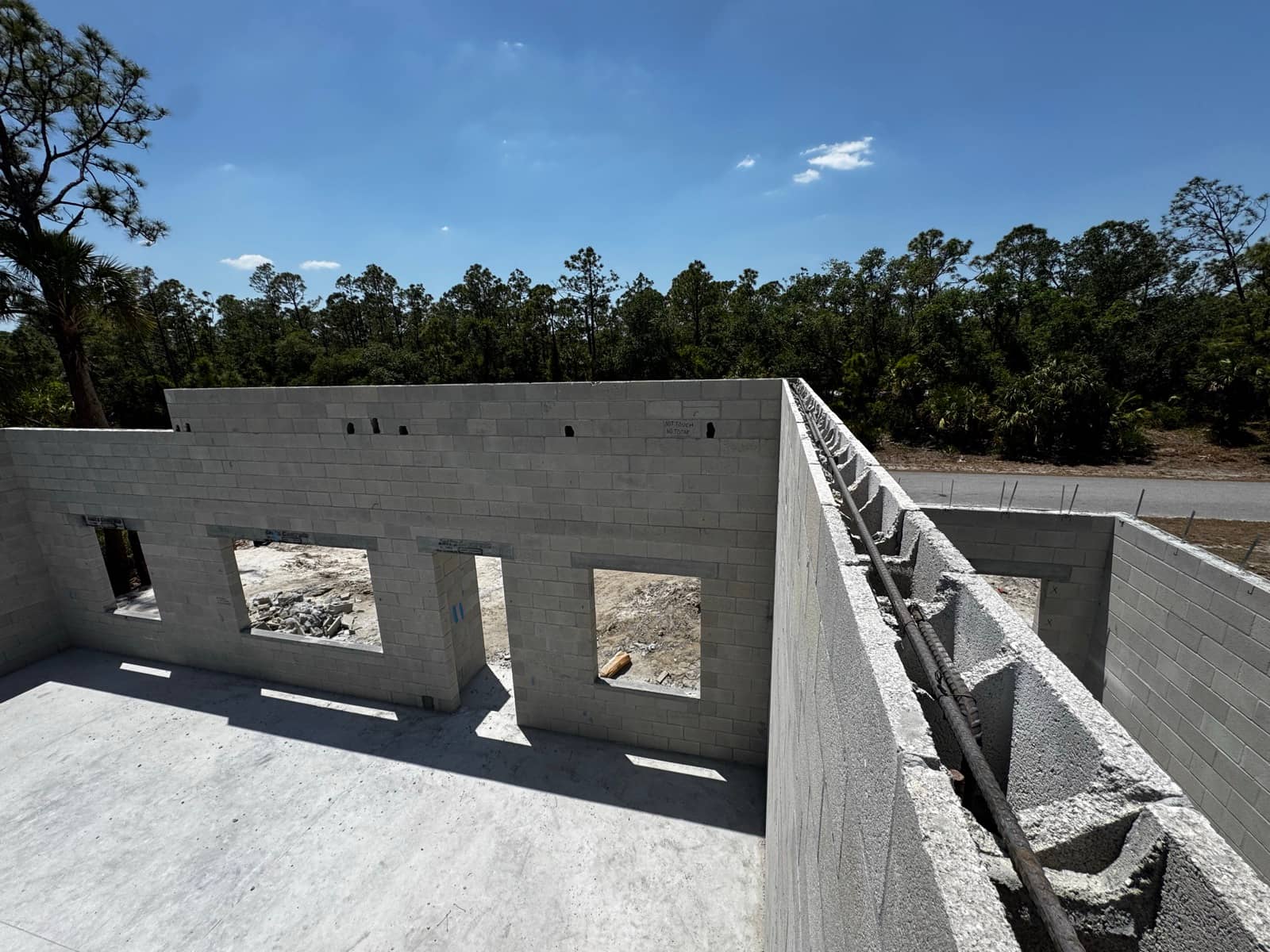 Block walls with bond beam rebar, elevated view | concrete and foundation work in North Port, FL by Sosnin Builders