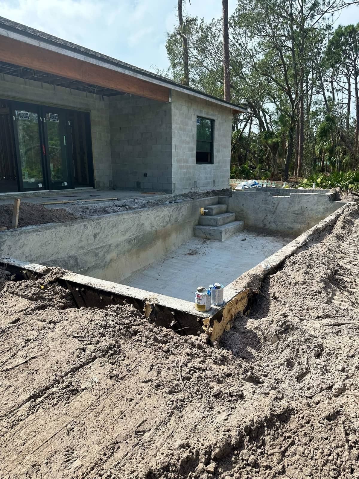 Pool shell excavation beside block home | concrete and foundation work in Port Charlotte, FL by Sosnin Builders