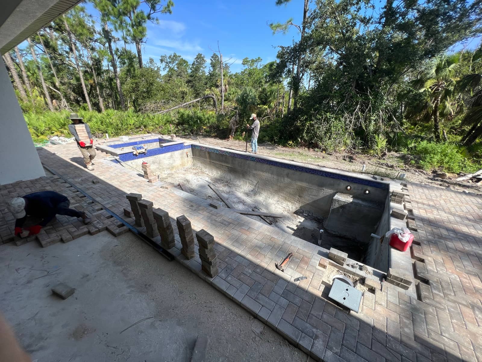 Pool tile and paver deck installation crew | concrete and foundation work in Port Charlotte, FL by Sosnin Builders