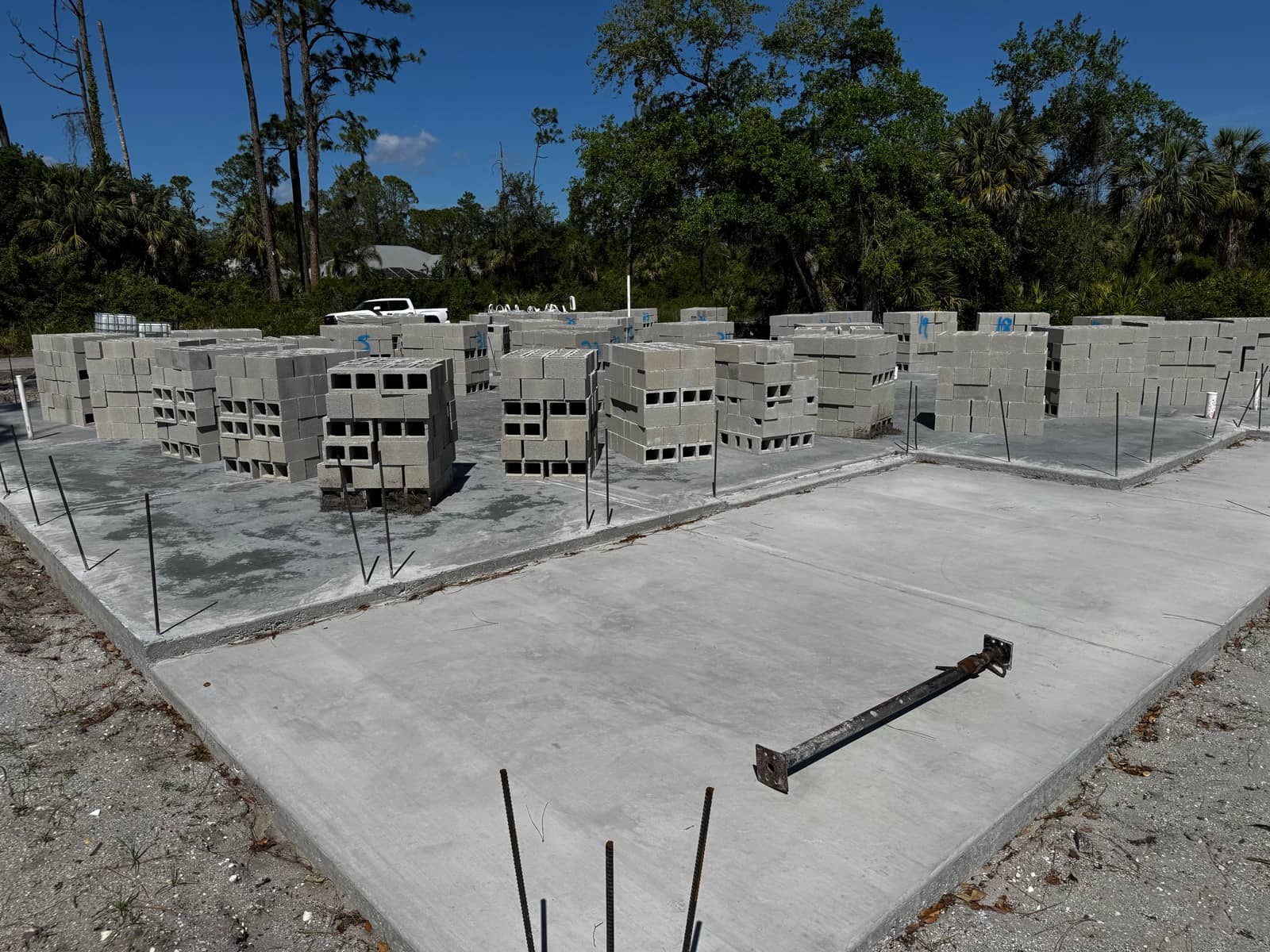 Block pallets staged on fresh slab | concrete and foundation work in Port Charlotte, FL by Sosnin Builders