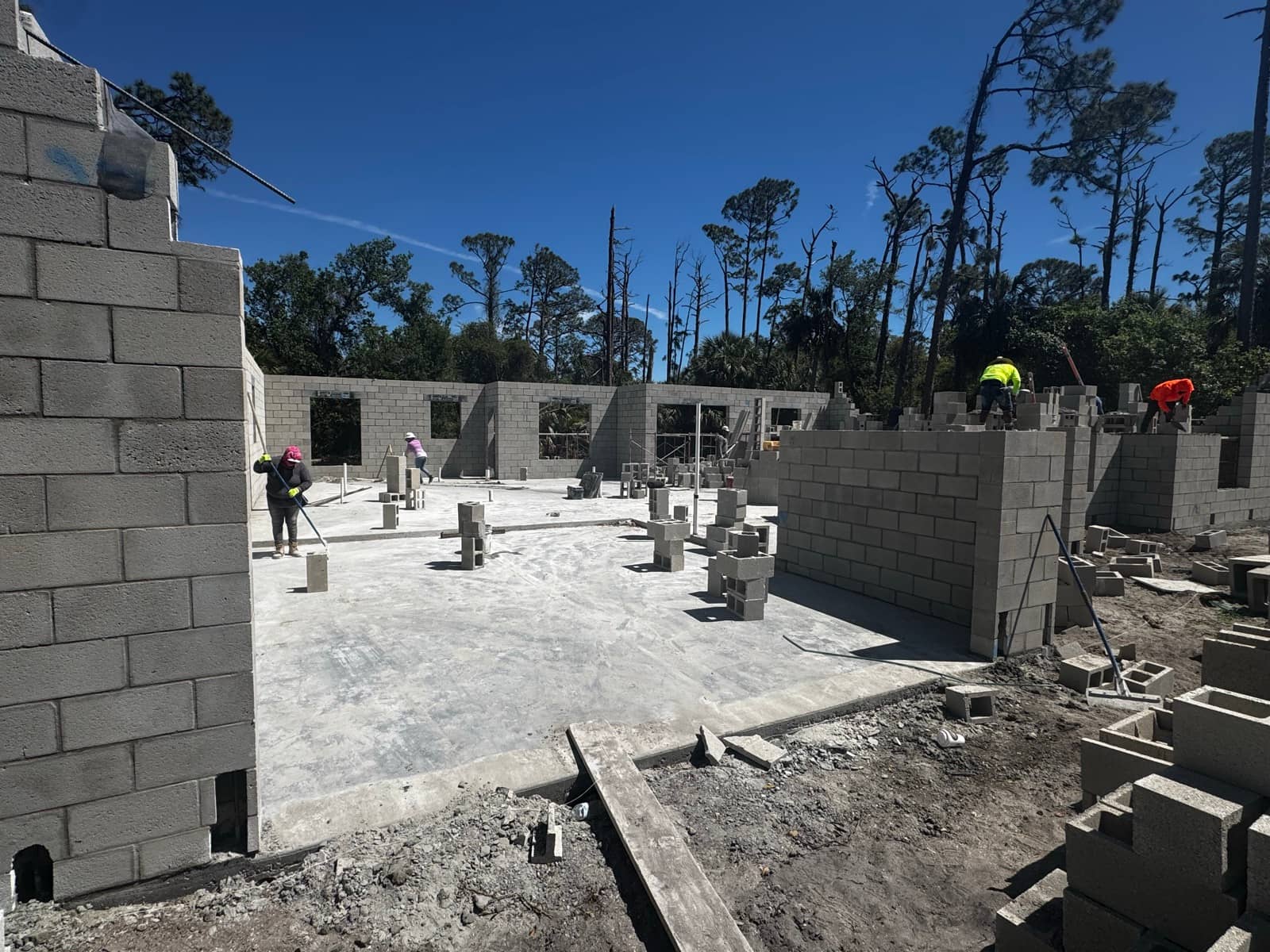 Masonry crew laying block walls on slab | concrete and foundation work in Port Charlotte, FL by Sosnin Builders