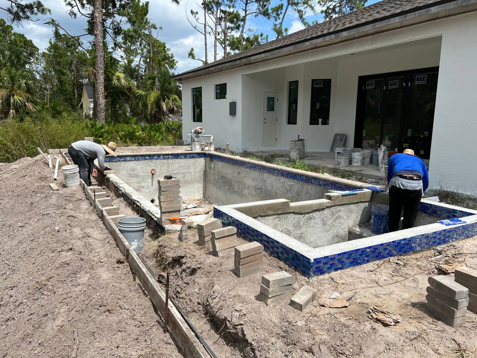 Pool and spa shell, waterline tile work | construction work in progress in Port Charlotte, FL by Sosnin Builders