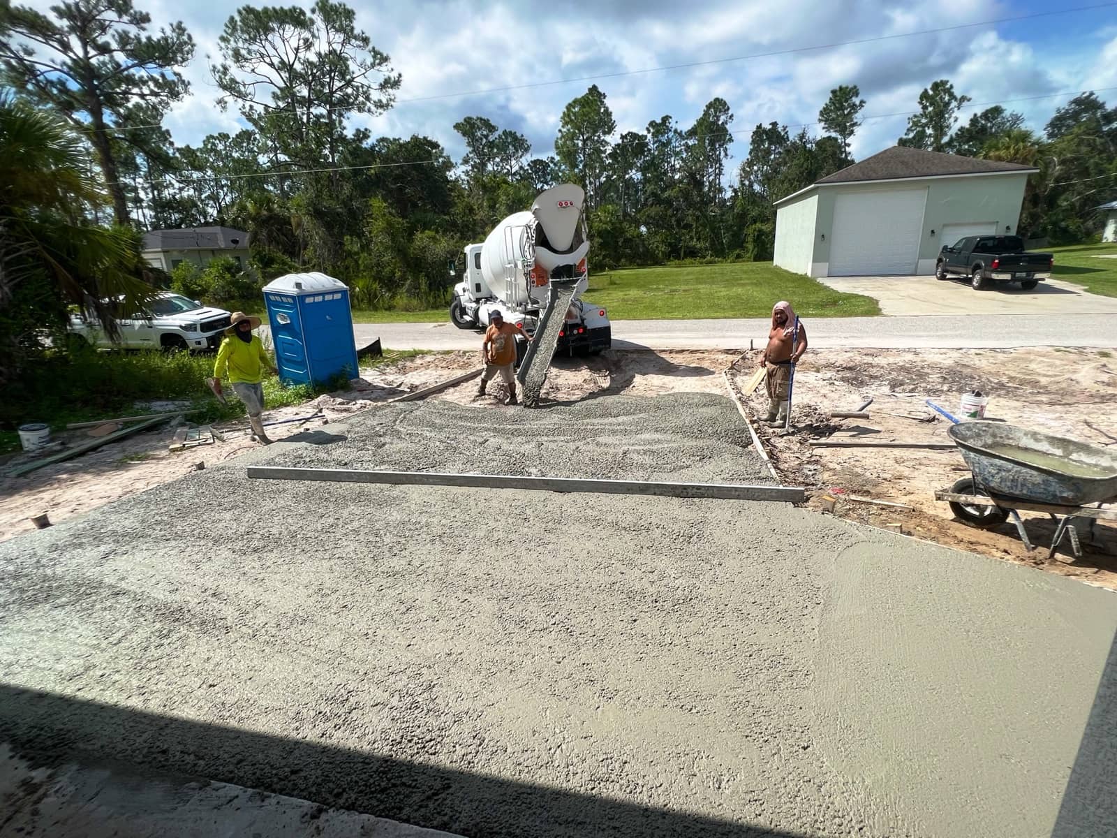 Driveway concrete pour with mixer truck | construction work in progress in Port Charlotte, FL by Sosnin Builders