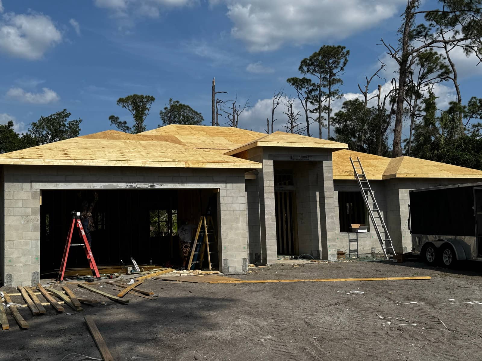 Block home with roof sheathing, front view | construction work in progress in Port Charlotte, FL by Sosnin Builders