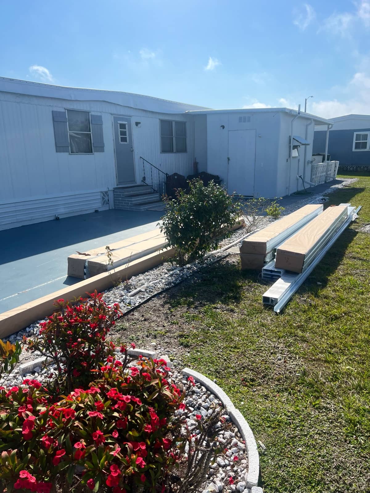 Carport materials staged at mobile home | construction work in progress in Venice, FL by Sosnin Builders