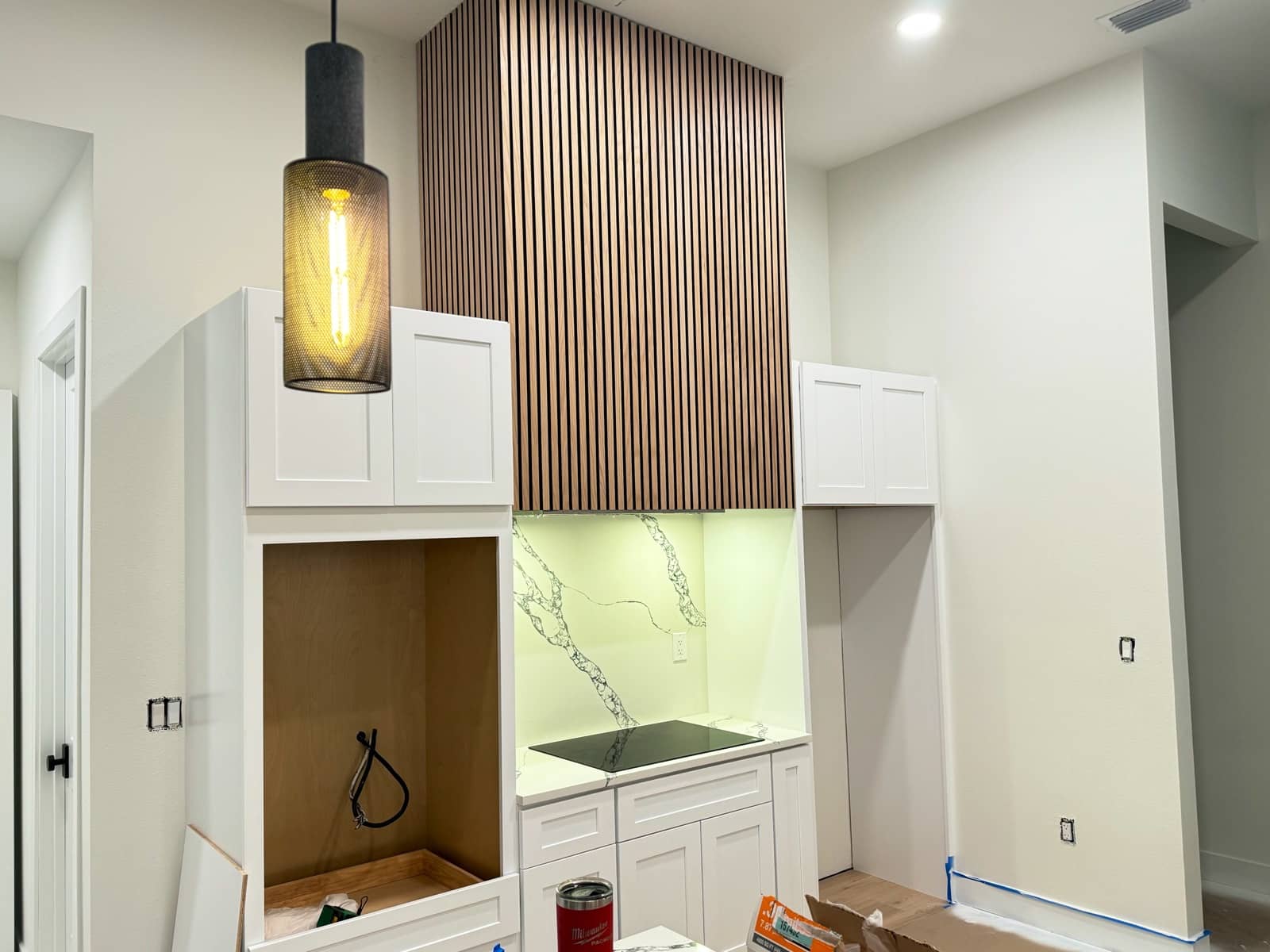 Slat-wood range hood and pendant light detail | custom home building in Port Charlotte, FL by Sosnin Builders