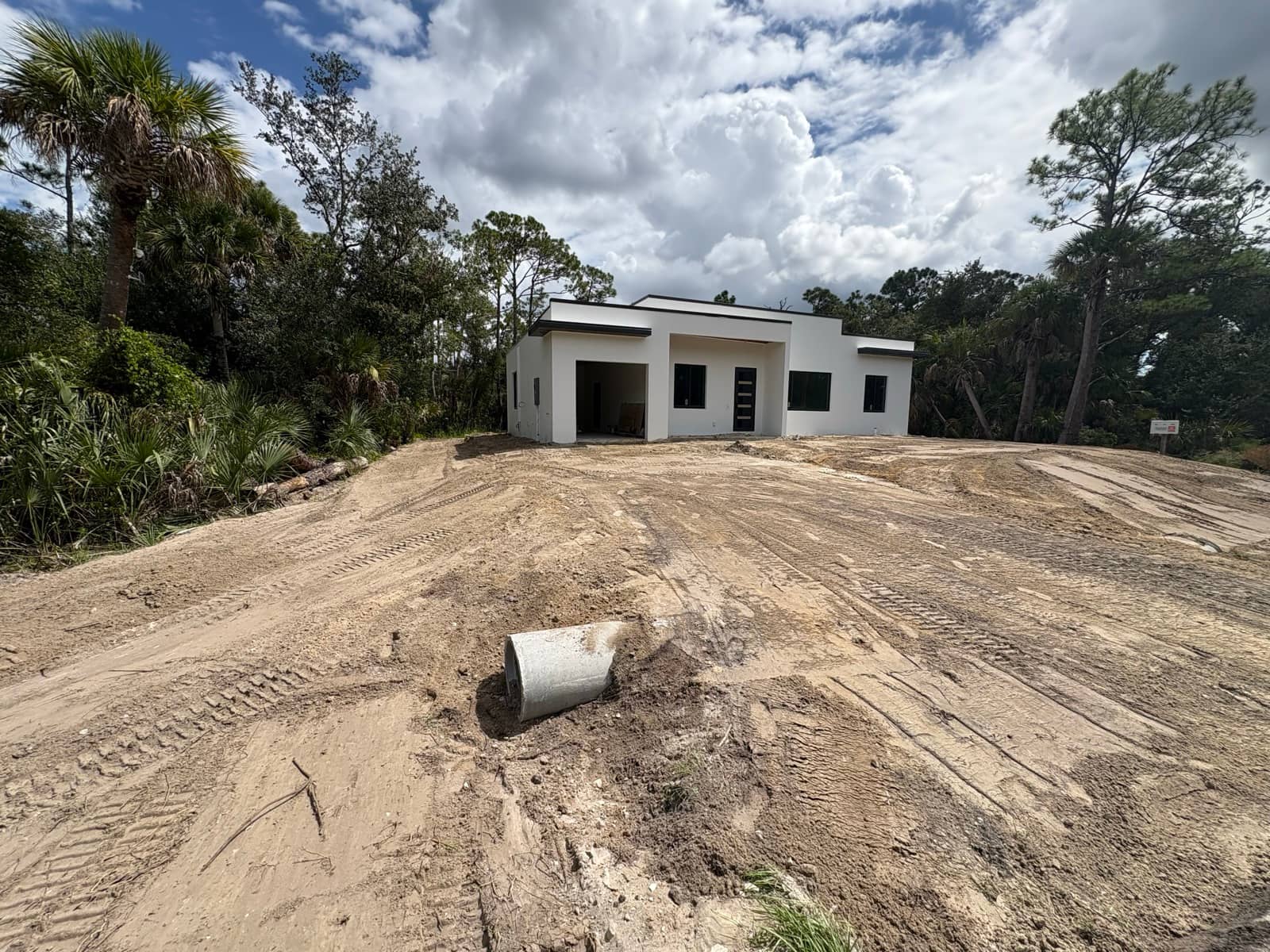 Modern flat-roof home after stucco and paint | new home construction in North Port, FL by Sosnin Builders