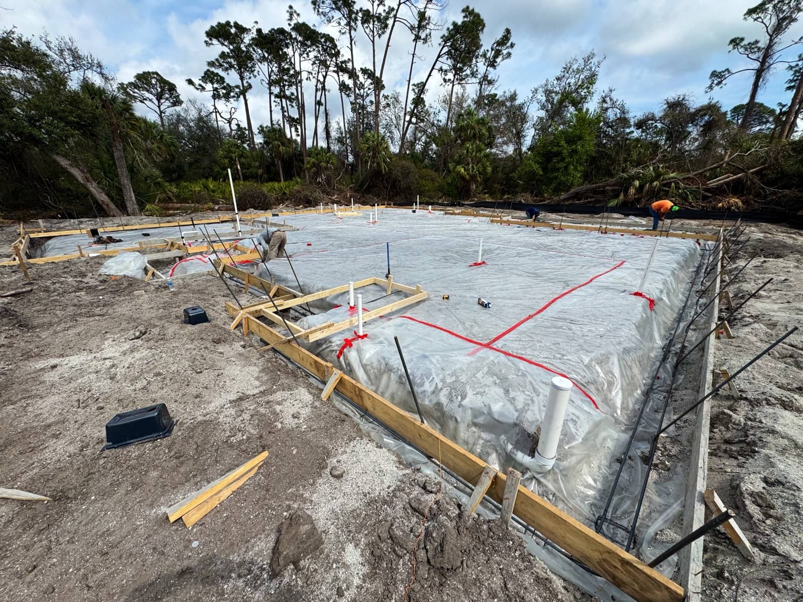 Vapor barrier and forms before slab pour | new home construction in Port Charlotte, FL by Sosnin Builders