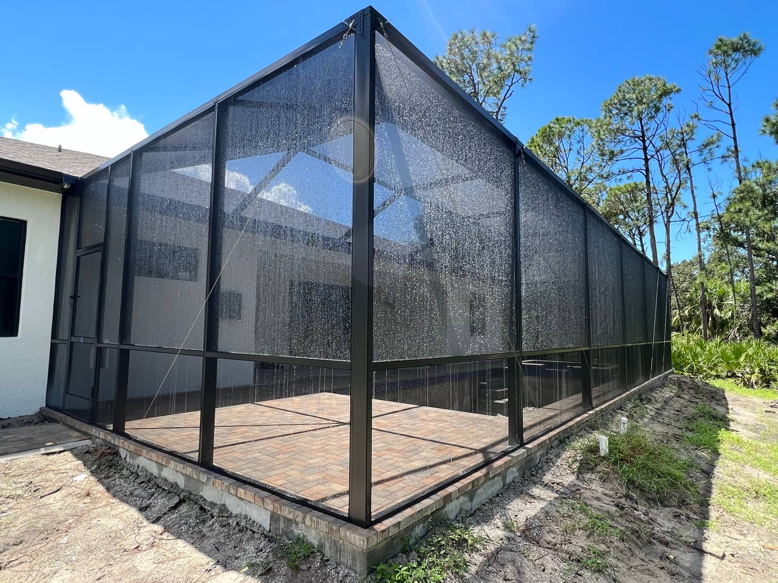 Pool cage exterior corner, new build | screen enclosure work in Port Charlotte, FL by Sosnin Builders
