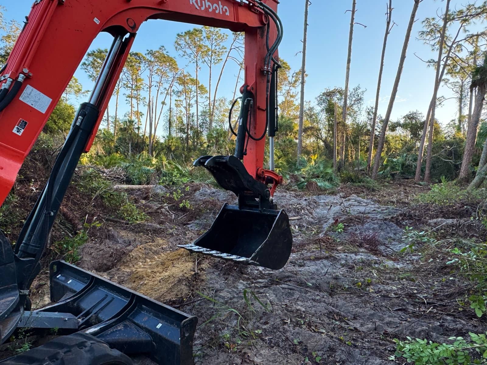 Excavator bucket close-up, land clearing | site preparation and excavation in Port Charlotte, FL by Sosnin Builders