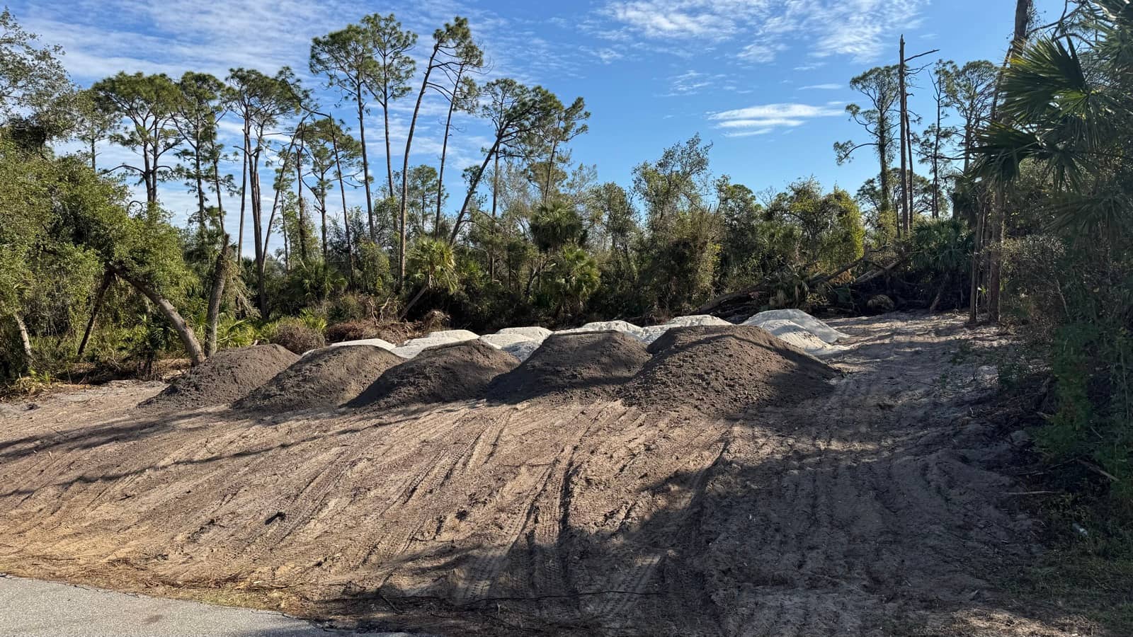 Fill dirt piles on cleared homesite | site preparation and excavation in Port Charlotte, FL by Sosnin Builders