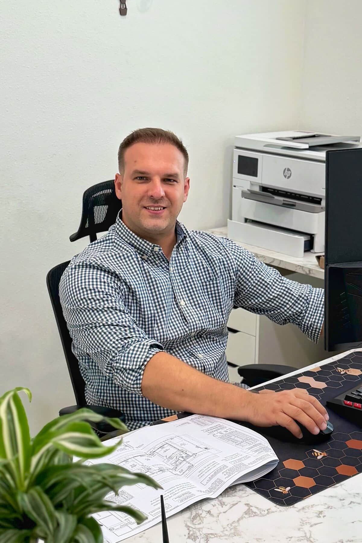Tony Sosnin at his desk reviewing permit drawings, Port Charlotte, Florida