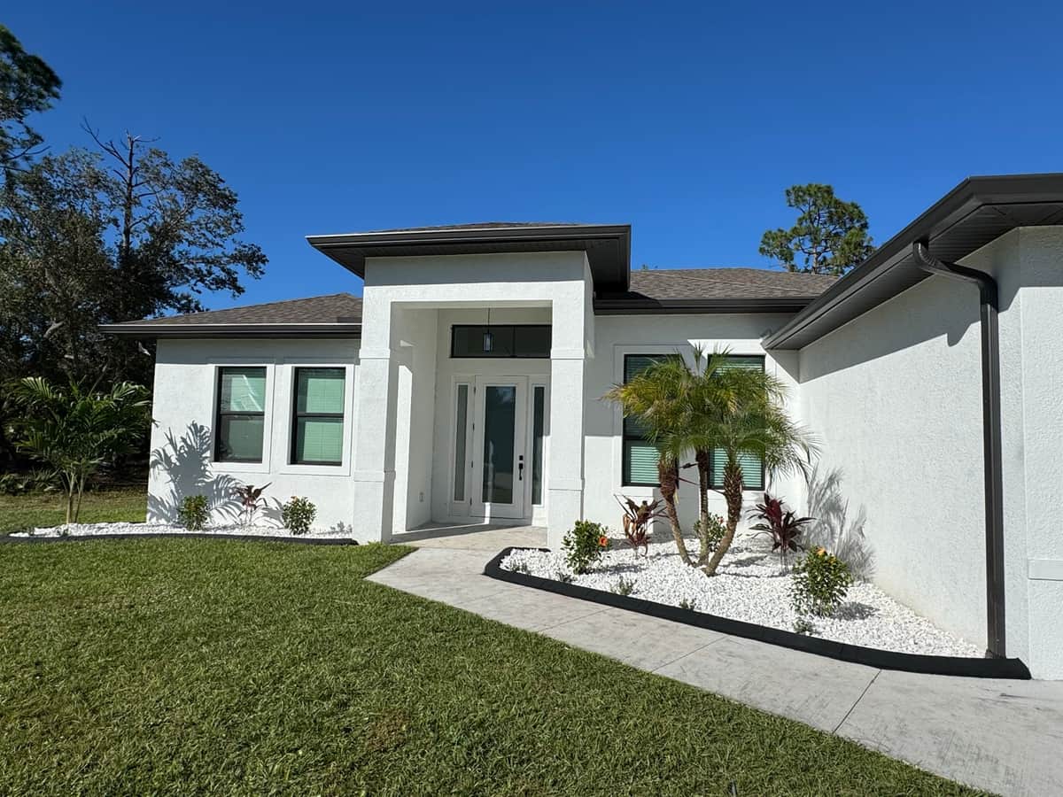 Finished white stucco home front exterior | custom home building in Port Charlotte, FL by Sosnin Builders