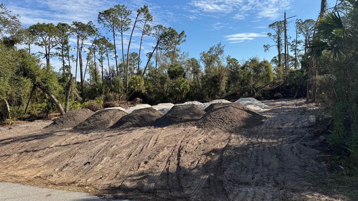 Fill dirt piles on cleared homesite | site preparation and excavation in Port Charlotte, FL by Sosnin Builders