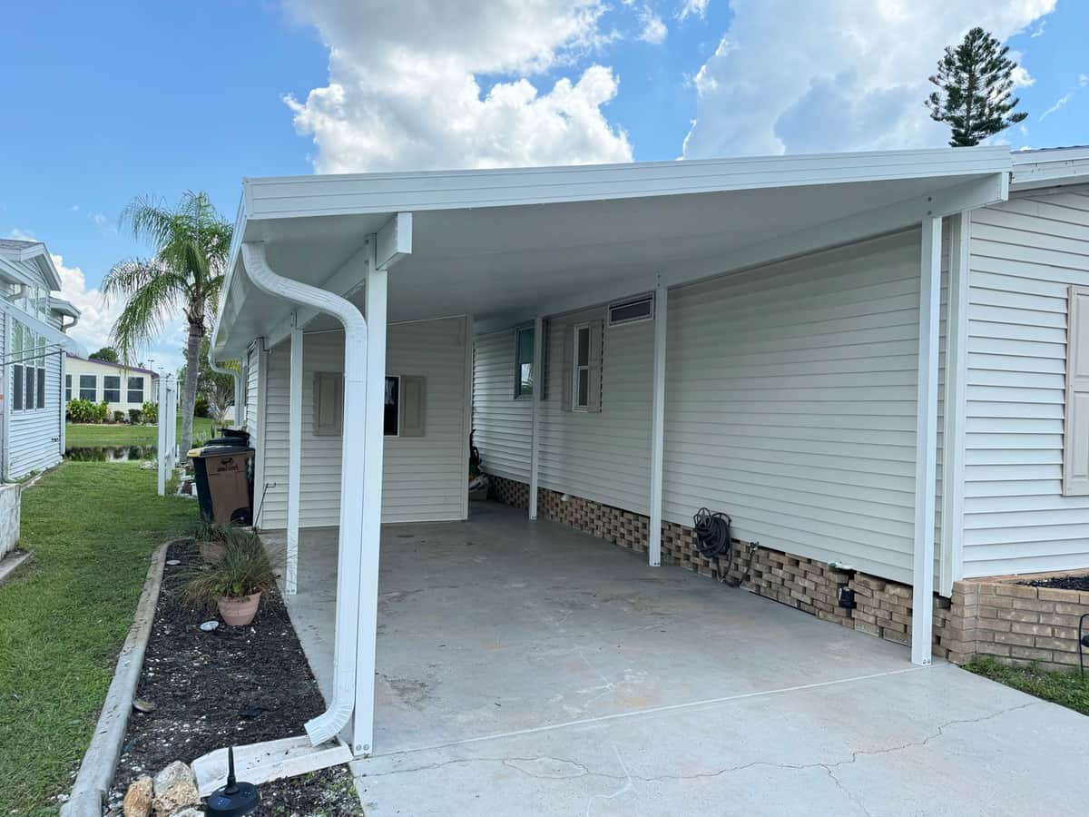 Attached aluminum carport with new fascia and gutters on a Port Charlotte home